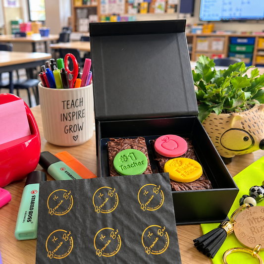 A mini gift box with two bars of chocolate brownies on a teacher's desk - perfect teachers' gift!